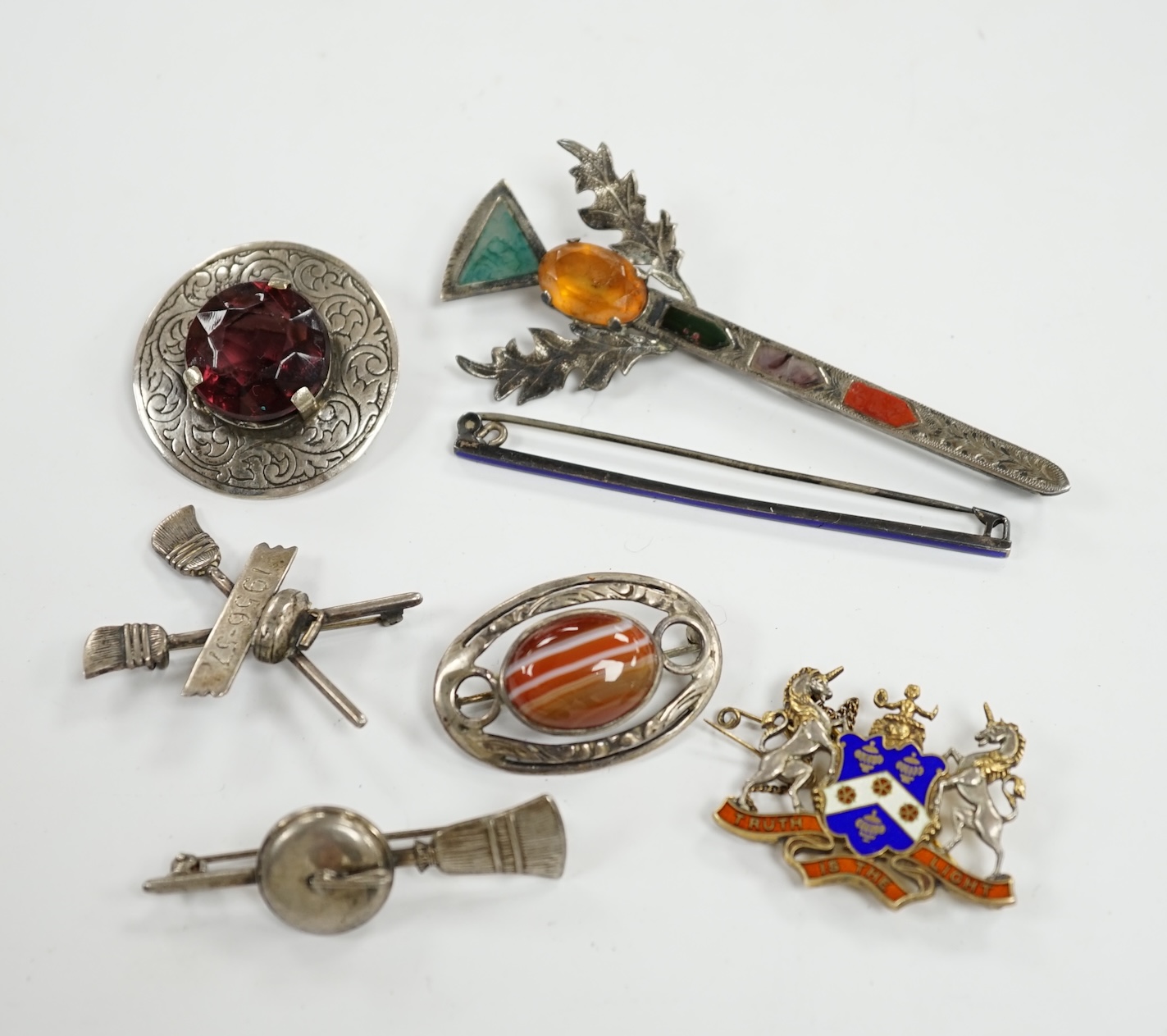 A 1950's Scottish silver, gem and Scottish hardstone set brooch, 91mm, together with six other brooches including four sterling and one silver. Condition - fair